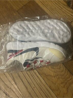 Nike Kids White Sneakers with Black Swoosh and Red Accents